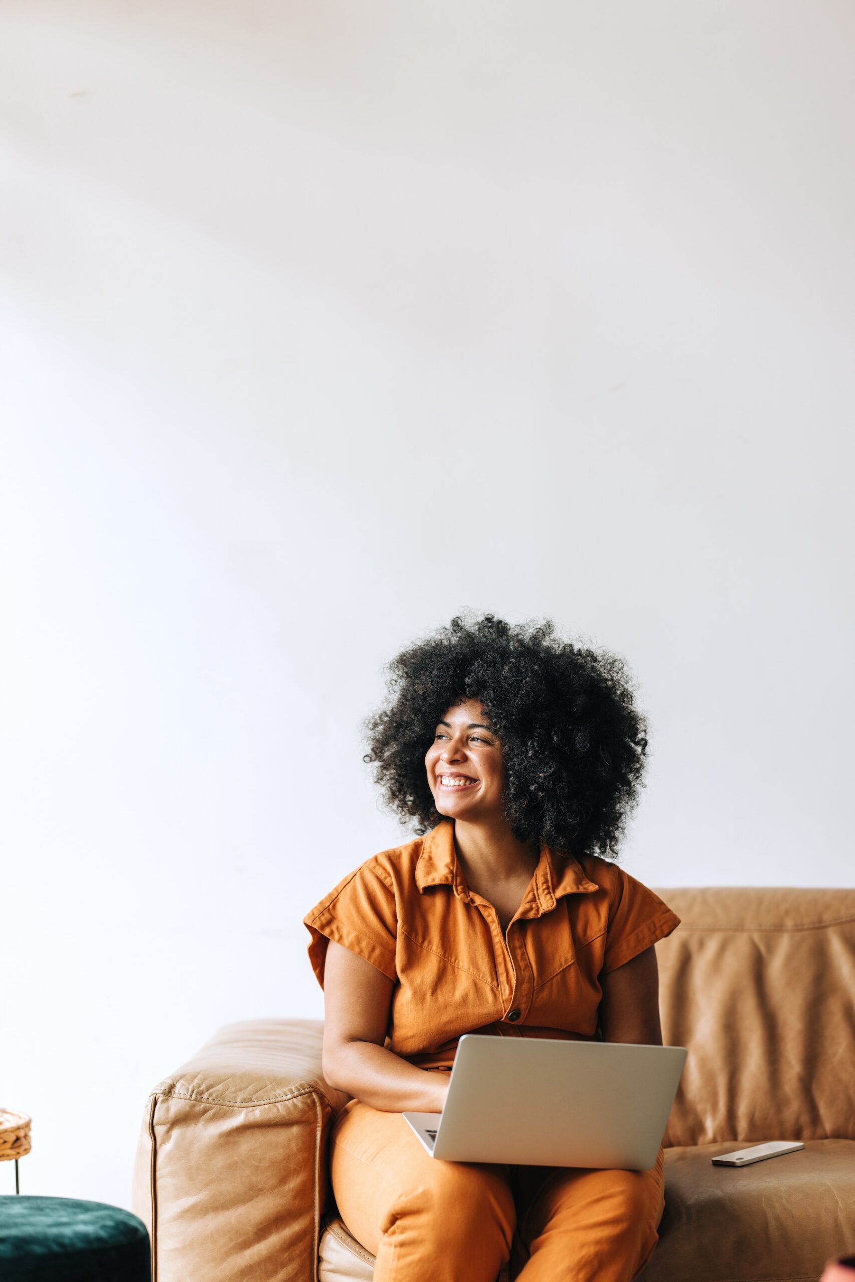 Black businesswoman looking away with a cheerful smile while